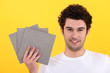 Man holding up tiles