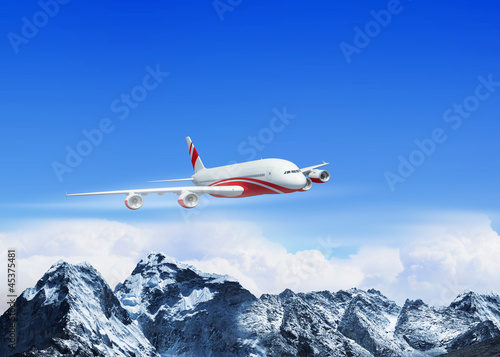 Photo: White passenger plane above the mountains White passenger plane above the mountains