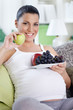 Pregnant woman eating fruits