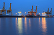 Container Cargo freight ship with working crane bridge in shipya