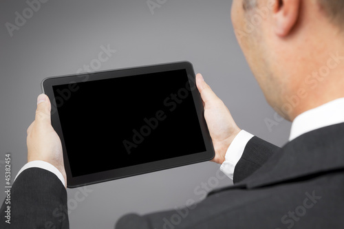 Photo: business man reading tablet pc business man reading tablet pc