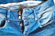 Blue jeans with unfasten buttons closeup