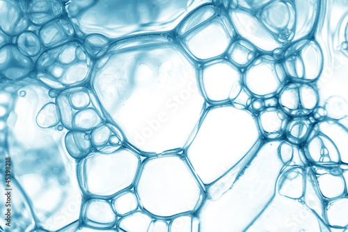 Photo: Blue oil bubbles in water close up. Blue oil bubbles in water close up.