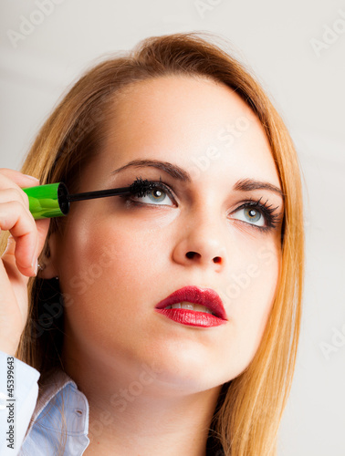 Photo: Woman applying mascara Woman applying mascara