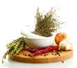 dried herbs in mortar and vegetables, isolatrd on white