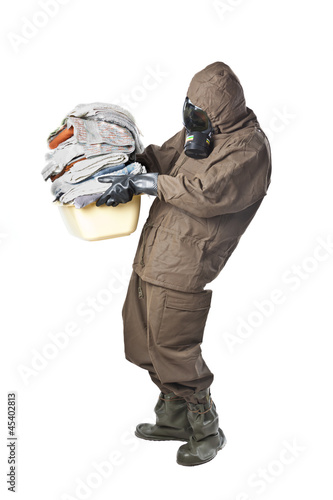 Photo: Man in Hazard Suit holding dirty towels Man in Hazard Suit holding dirty towels
