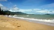 Young boy runs along the beach