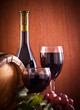 Red wine glass and Bottle on a wooden background