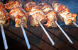Shish kebab: slices of meat with sauce preparing on fire