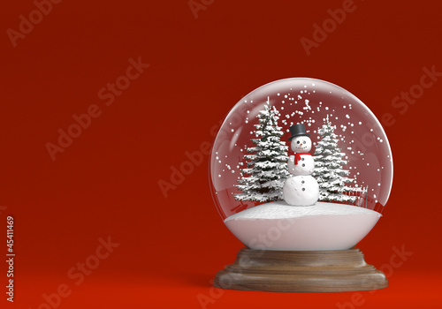 Photo: snowglobe with snowman and trees on a red background copy space snowglobe with snowman and trees on a red background copy space