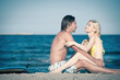 Couple at the beach with surfboard.