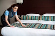 Adding final touches to bedroom before customer arrival