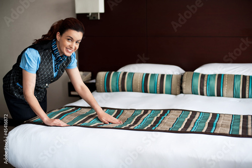 Photo: Adding final touches to bedroom before customer arrival Adding final touches to bedroom before customer arrival