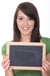 woman holding a blackboard left blank for a message