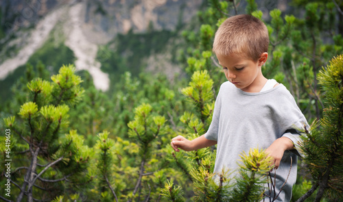Photo: Portrait of four year old boy walking outdoors in the mountains. Portrait of four year old boy walking outdoors in the mountains.