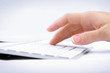 Woman's hand typing on computer keyboard