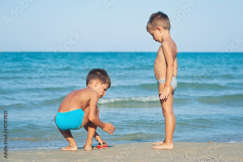 Photo: Two brothers playing on the beach. Two brothers playing on the beach.