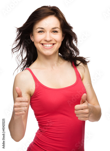Photo: Woman is showing thumb up gesture Woman is showing thumb up gesture