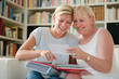 Photo: Mother and daughter looking at pictures in photo album Mother and daughter looking at pictures in photo album