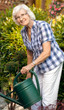 Seniorin wässert Garten