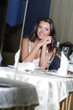 Photo: portrait of young happy beautiful woman in restaurant portrait of young happy beautiful woman in restaurant