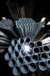 Steel pipes bundled together in a warehouse.