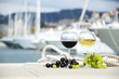 Wineglasses and grapes on the yacht pier of La Spezia, Italy