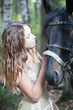 Attractive blond girl with her horse.