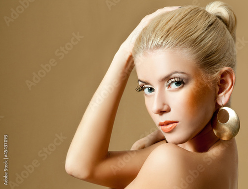 Photo: beautiful blonde in gold earrings beautiful blonde in gold earrings