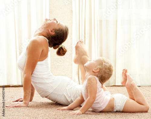 Photo: Mother and daughter doind exercise Mother and daughter doind exercise