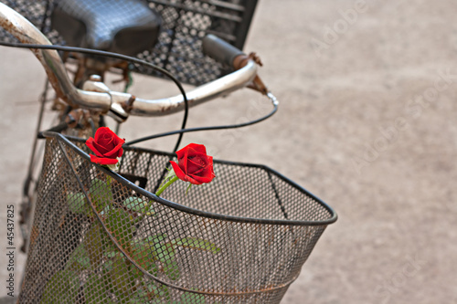 Photo: Red roses in basket of old rusty bicycle Red roses in basket of old rusty bicycle