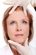 Photo: Face of woman and doctor hands. Plastic surengy concept. Face of woman and doctor hands. Plastic surengy concept.