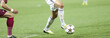 Soccer players running after the ball