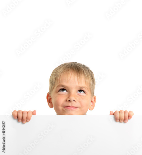 Photo: Cute boy holding white board and looking up Cute boy holding white board and looking up