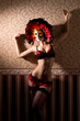 A young woman in red lingerie and a Venetian mask