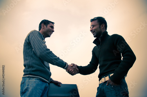 Photo: Shaking hand of indian young happy people Shaking hand of indian young happy people