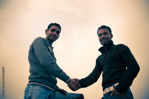 Photo: Shaking hand of indian young happy people Shaking hand of indian young happy people