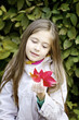 Girl with autumn read leaf