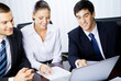 Three businesspeople working with laptop