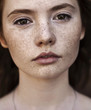 Portrait of a beautiful brunette with freckles