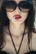 beautiful brunette with glasses smoking