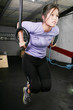 young woman on rings on gym