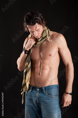 Photo: Portrait of confident young man shirtless with jeans Portrait of confident young man shirtless with jeans