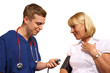Doctor taking blood pressure of mature female patient