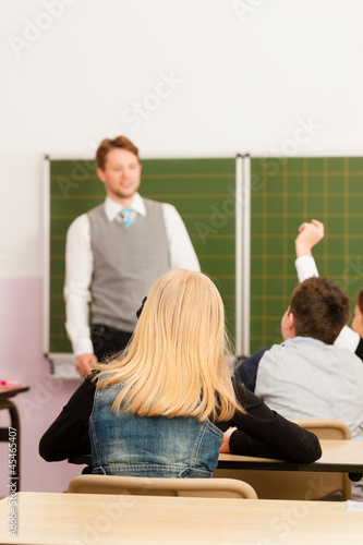 Photo: Education - Teacher with pupil in school teaching Education - Teacher with pupil in school teaching