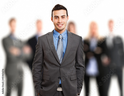 Photo: Businessman in front of his team Businessman in front of his team
