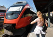 Girl at the train looking at her watch