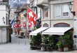 Old street in Zurich decorated with flags for the Swiss National