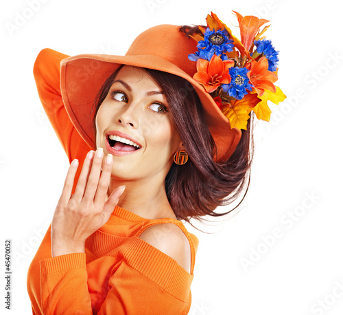 Photo: Woman wearing orange hat with flower. Woman wearing orange hat with flower.