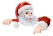 Christmas Santa pointing down at sign